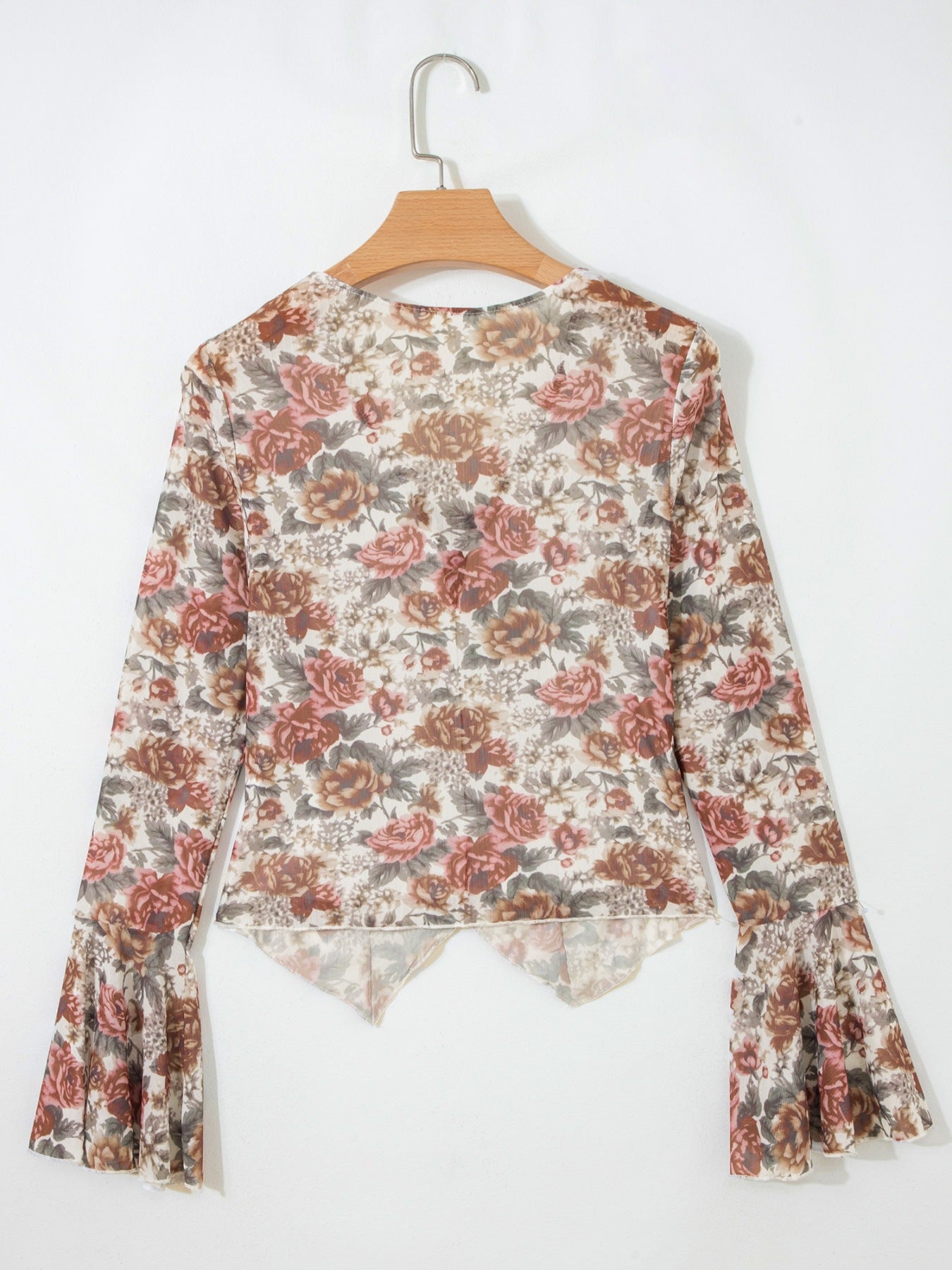 Charming floral print mesh blouse with bell sleeves and a ruffled hem.