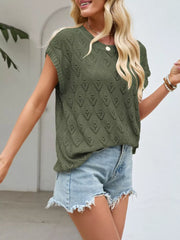 Green openwork knit top with diamond pattern, short sleeves, and V-neck, styled with denim shorts.