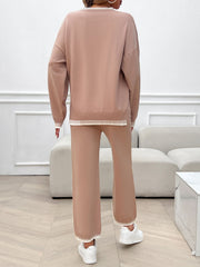 Pale blush knit lounge set with ribbed trim detail on neckline, cuffs, and hem.