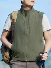 Men's matcha green zip up vest with stand collar and multiple pockets.