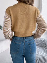 Tan cropped knit sweater with geometric stripe sleeves and V-neck.