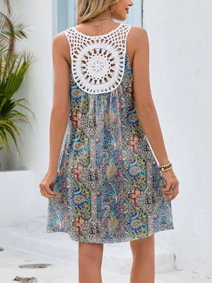 Botanical print mini dress with white crochet back detail and cutout.