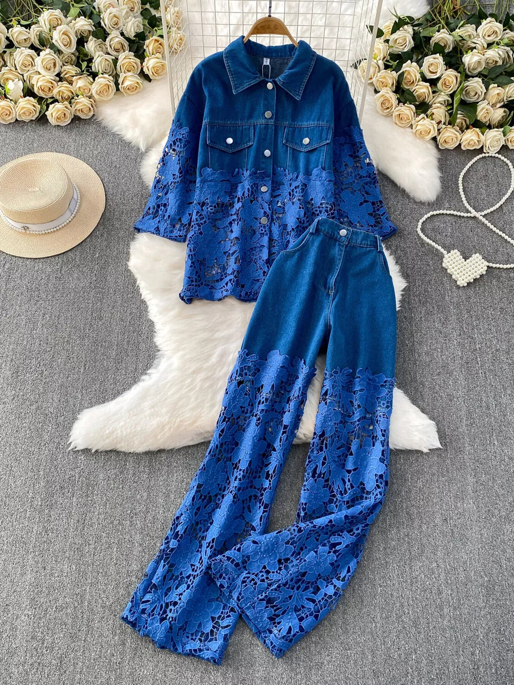 Blue denim two-piece set with lace-embellished sleeves and pant legs.