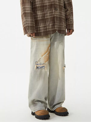Distressed light wash wide-leg jeans with unique patches and a worn look.