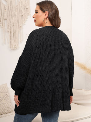 Black chunky knit cardigan with balloon sleeves and ribbed texture.