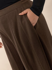 Dark brown palazzo trousers with pockets and a wide flare leg.