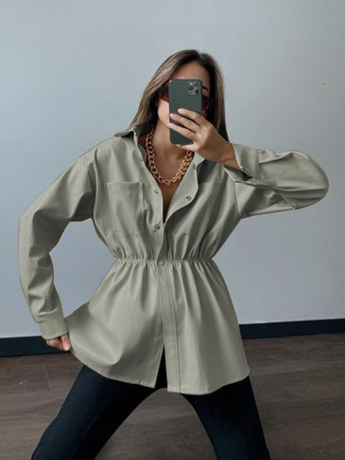 Matcha green faux leather shirt jacket with gathered waist and button front.
