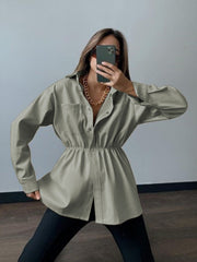 Matcha green faux leather shirt jacket with gathered waist and button front.