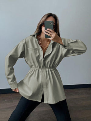Matcha green faux leather shirt jacket with gathered waist and button front.
