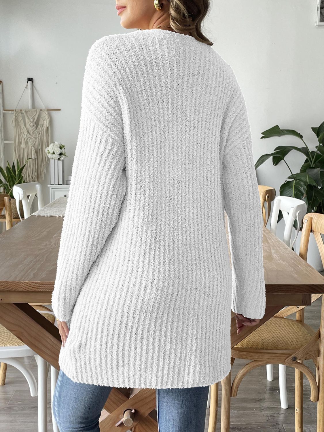 White textured bouclé open-front cardigan with long sleeves and a relaxed fit.
