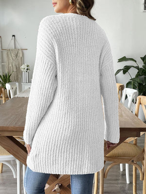 White textured bouclé open-front cardigan with long sleeves and a relaxed fit.