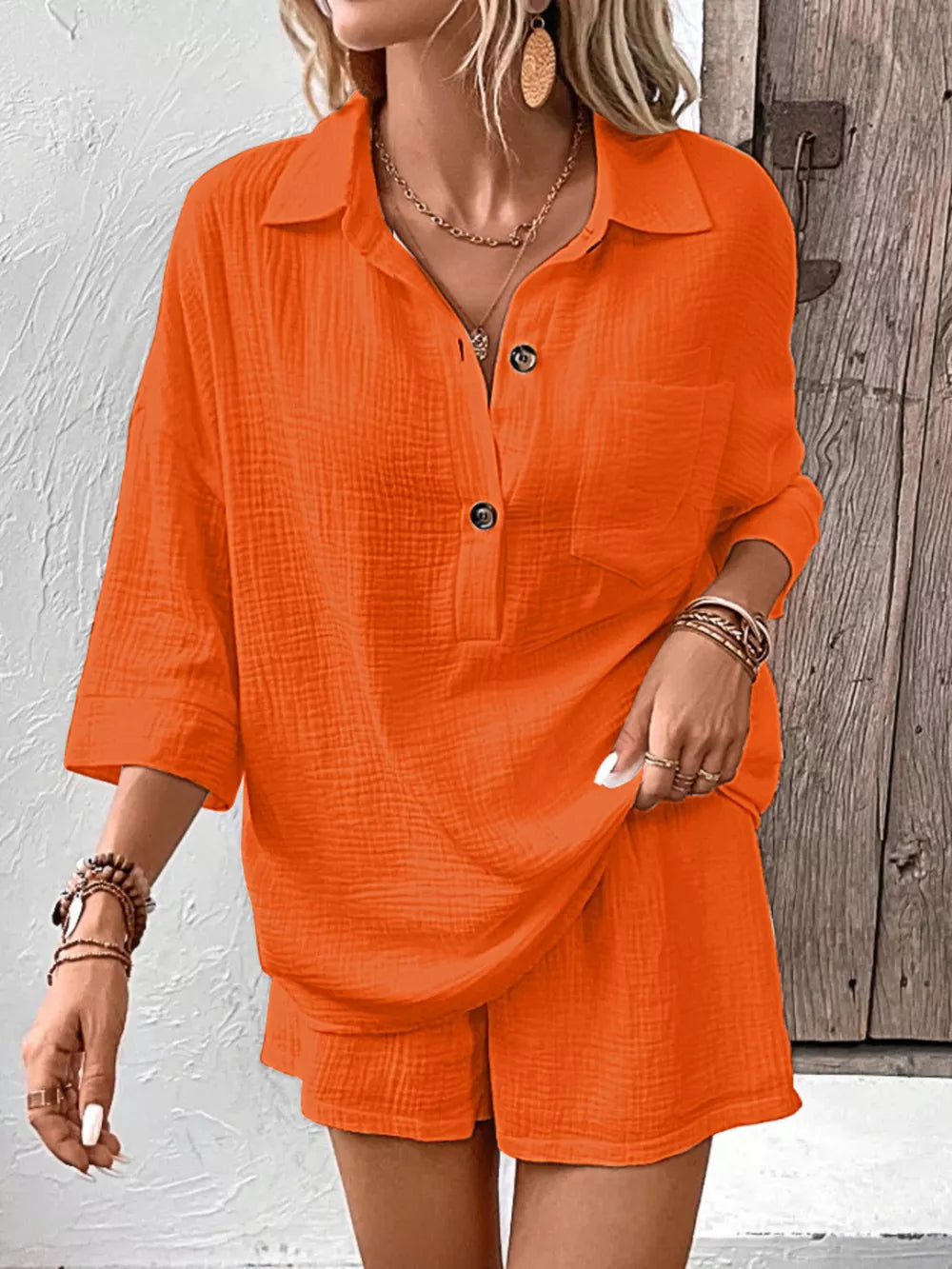 Crisp cotton two-piece set in orange-red with button-up shirt and shorts.