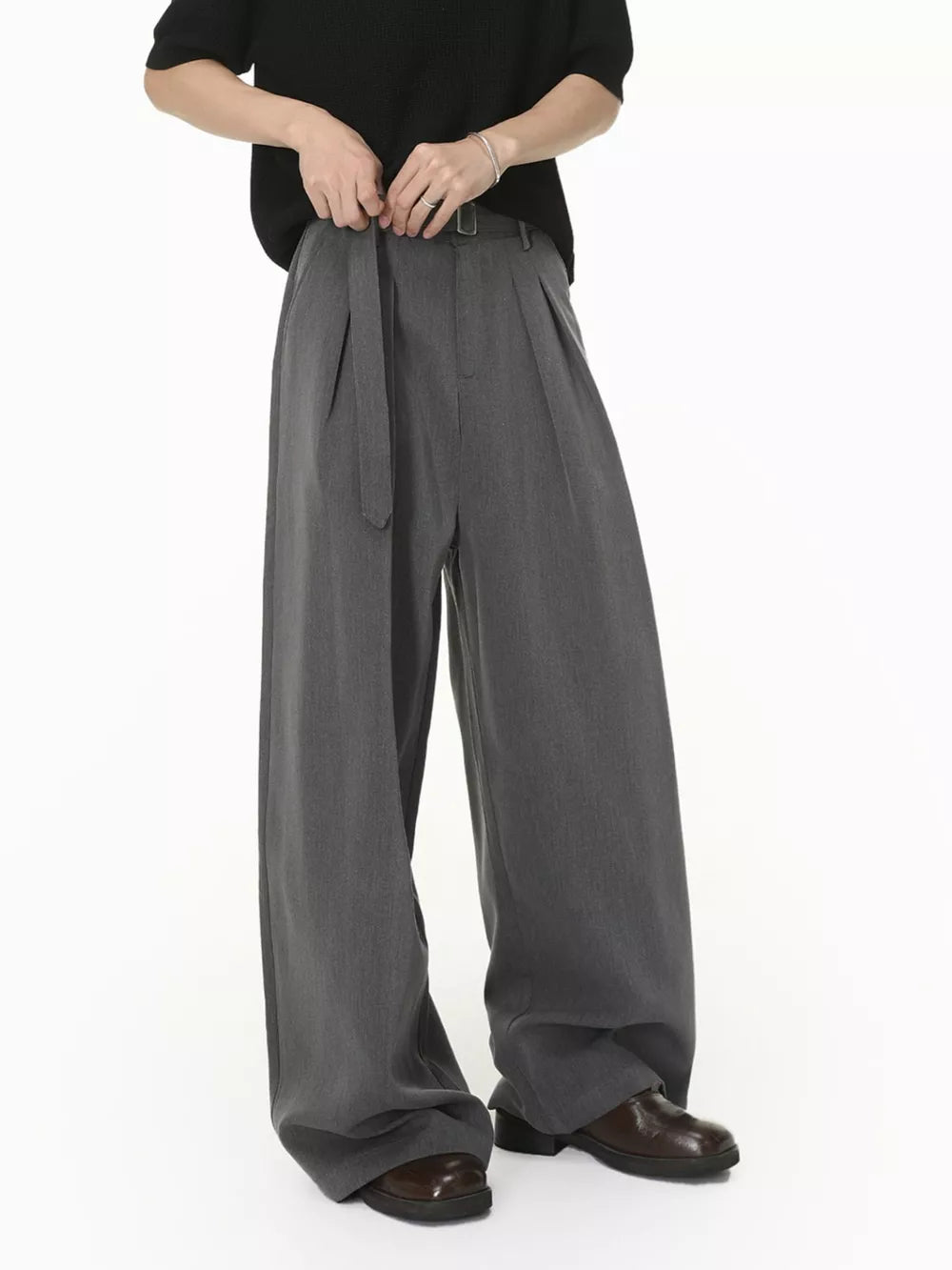 Grey wide-leg pleated sweatpants with a belted waist and contemporary fit.