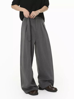 Grey wide-leg pleated sweatpants with a belted waist and contemporary fit.