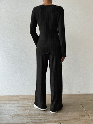 Black ribbed knit loungewear set with long sleeves and flared pants.