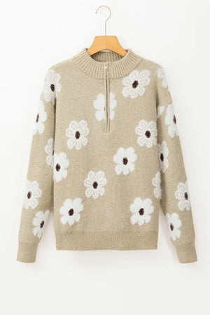 Tan acrylic mock neck sweater with white floral intarsia pattern and quarter zip.