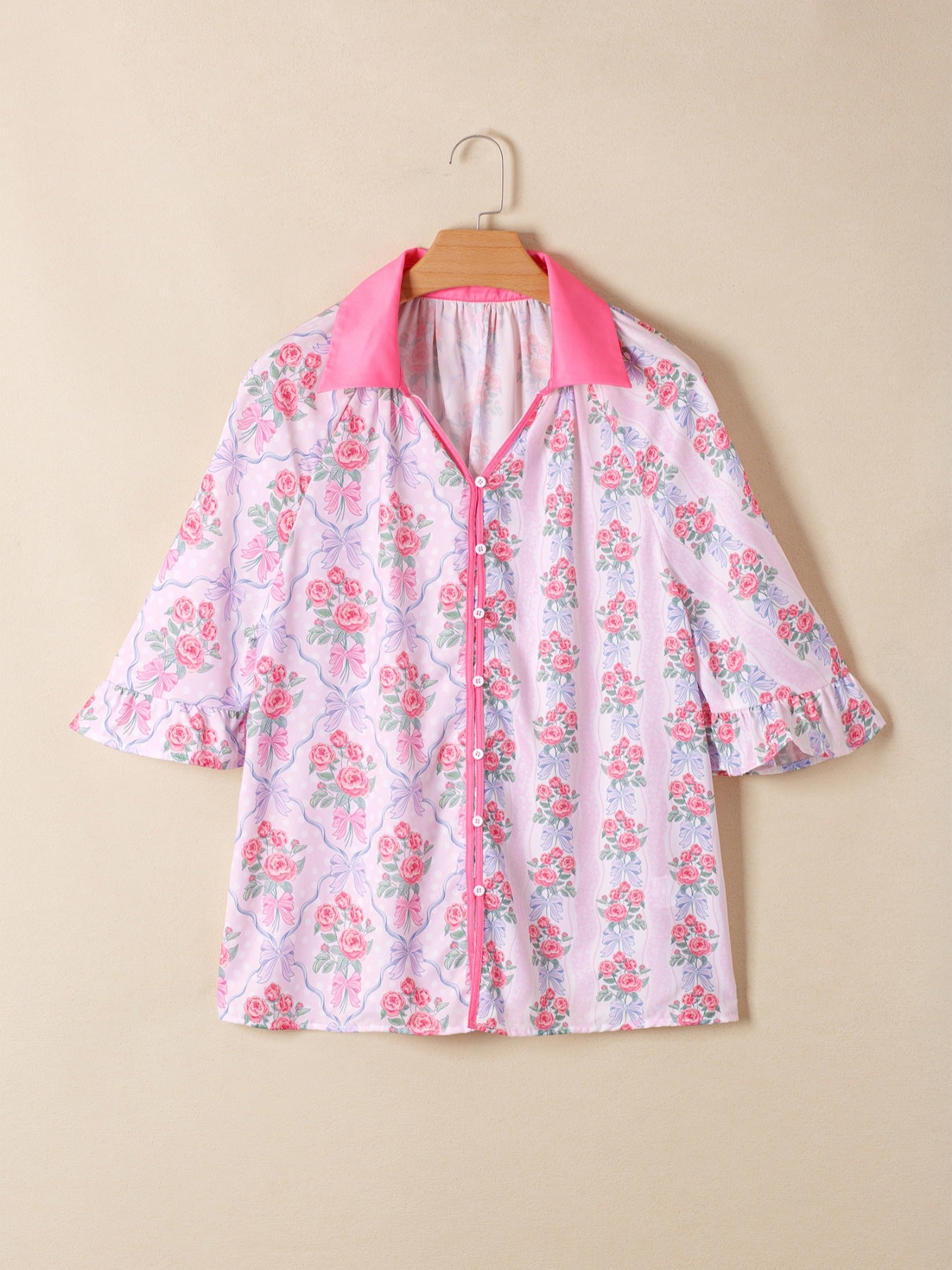 Maternity shirt with pink floral and bow print, ruffled sleeves, and button-up front.