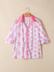 Maternity shirt with pink floral and bow print, ruffled sleeves, and button-up front.