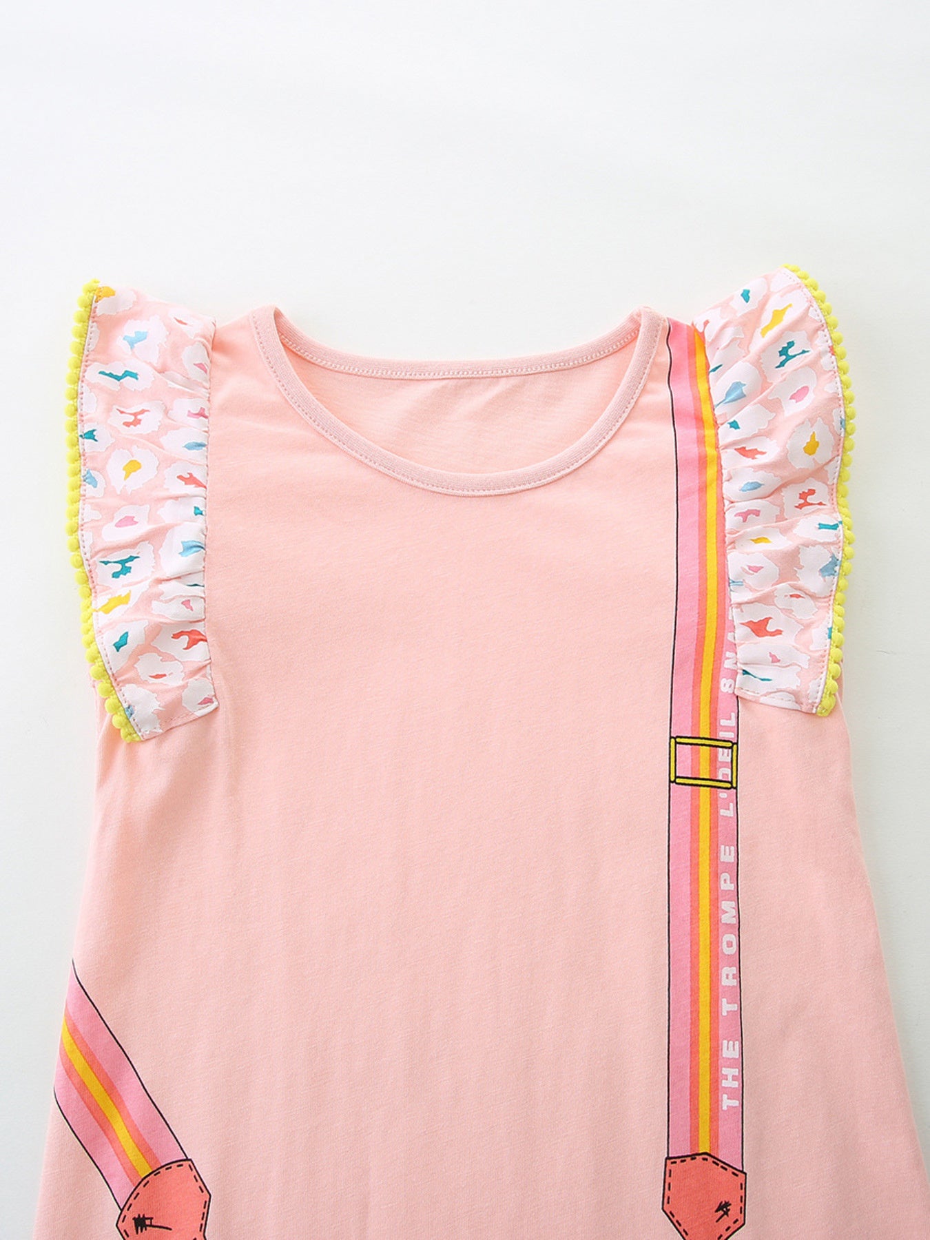 Pink cotton baby dress with ruffled cap sleeves, pom-pom trim, and cartoon bag strap design.