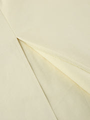 Chic cotton midi skirt in beige with a side slit detail.