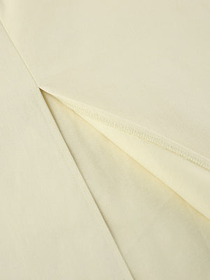 Chic cotton midi skirt in beige with a side slit detail.