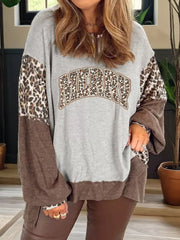 Leopard print graphic sweatshirt with colorblock sleeves and hem, featuring "MERRY" text.
