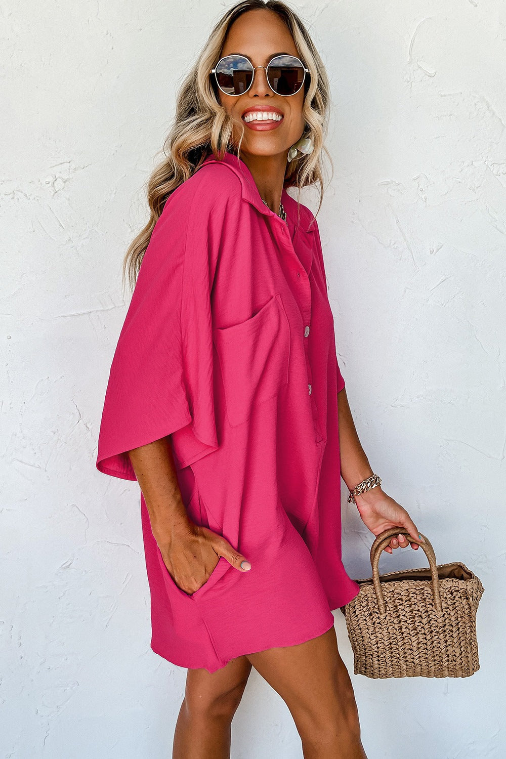 Oversized hot pink shirt romper with button front and pockets.