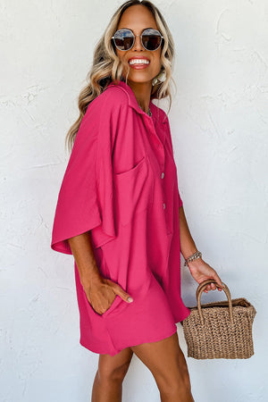 Oversized hot pink shirt romper with button front and pockets.