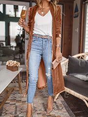 Terracotta velvet duster coat with fluid silhouette, open front, long sleeves, worn with jeans and heels.