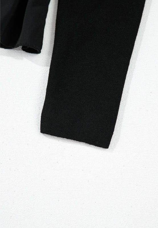 Black ribbed bodice peplum top with a ruffled hem detail.
