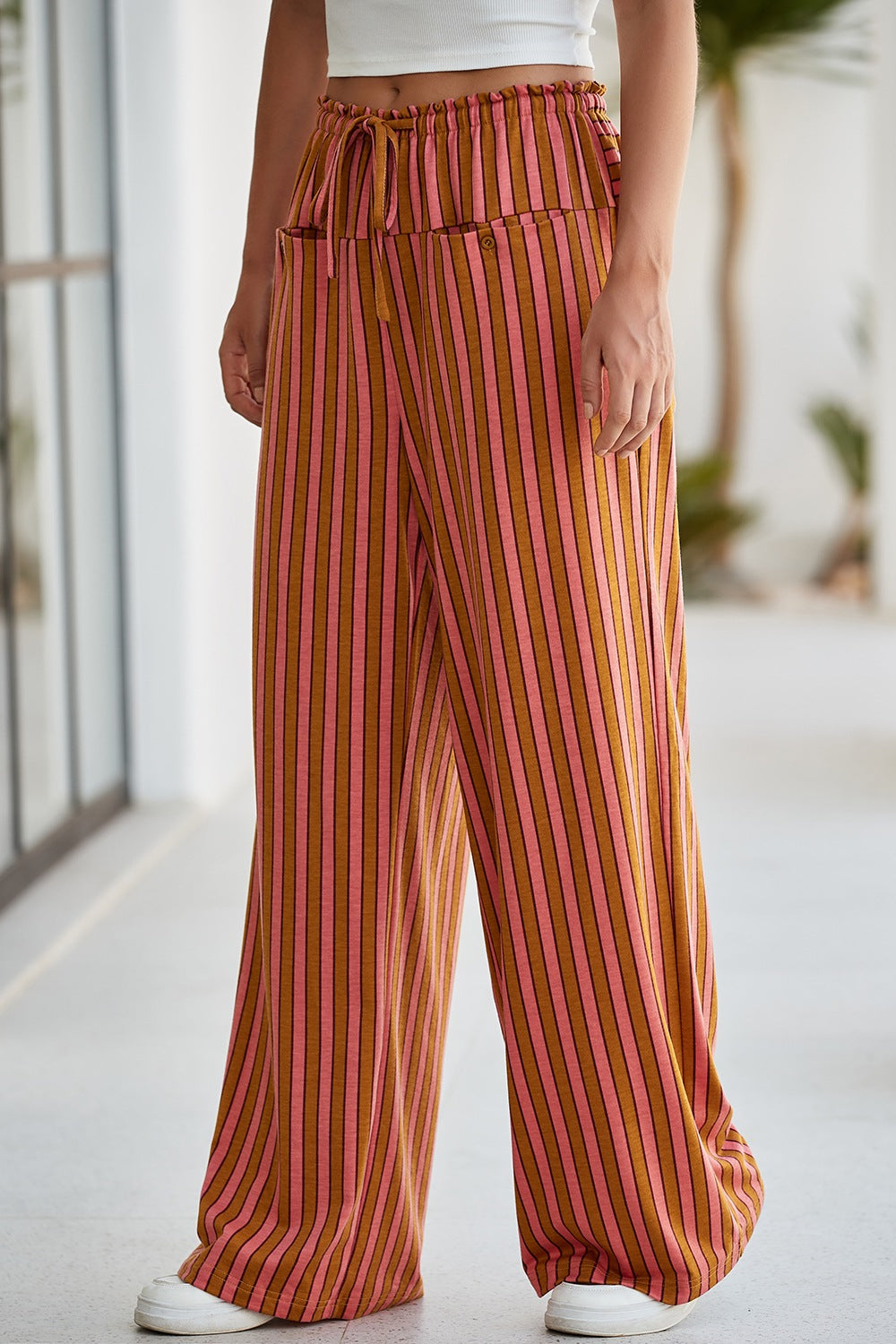 Wide leg pants with pink and brown stripes, drawstring waist, and pockets.