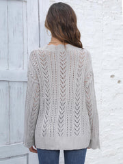 Openwork chevron knit sweater in dark gray acrylic with long sleeves and a V-neck.