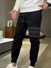 Men's black slim-fit sweatpants with drawstring and striped detail