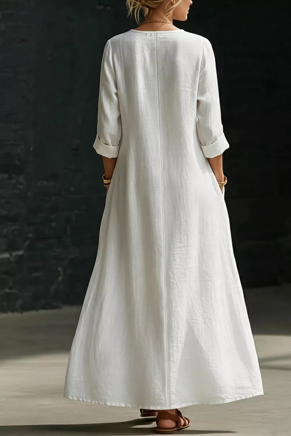 White maxi dress with buttoned detail, 3/4 sleeves, and cuffed sleeves.