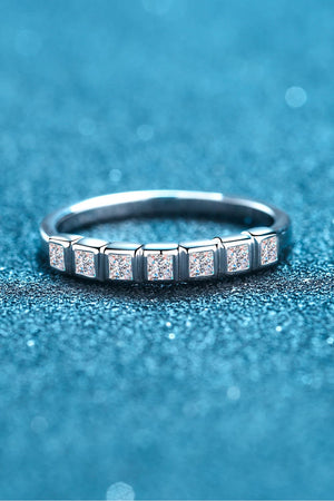 Silver band ring with princess cut diamonds in square settings