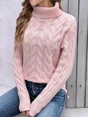 Pink cable-knit turtleneck sweater with long sleeves and ribbed cuffs.