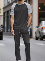 Men's grey and black two-piece loungewear set with drawstring pants and henley shirt.