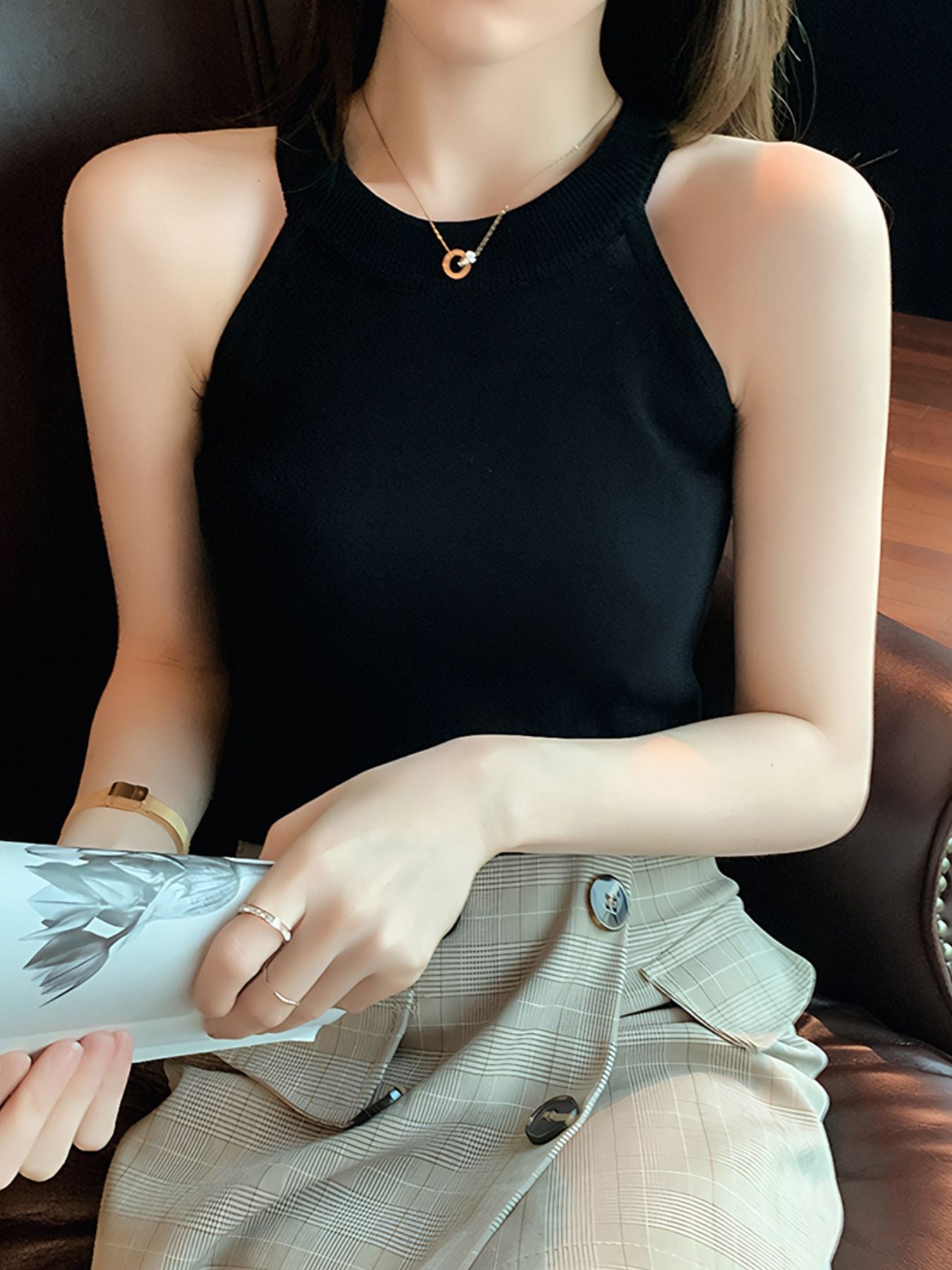 Black ribbed knit cami tank top with a mock neck and sleeveless design.