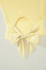 Yellow knit sweater vest with cutout back and large bow detail
