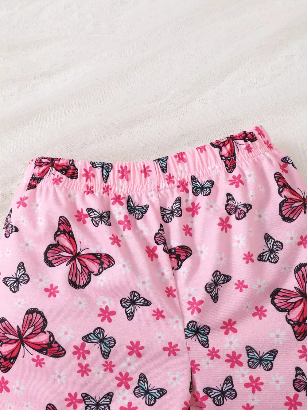 Pink baby girls' set with elastic waistband and allover butterfly and floral print.