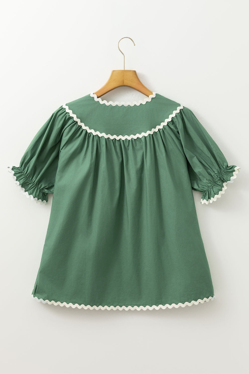 Moss green blouse with puff sleeves and scalloped trim neckline and cuffs.
