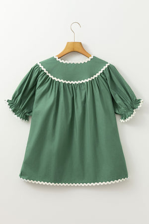 Moss green blouse with puff sleeves and scalloped trim neckline and cuffs.