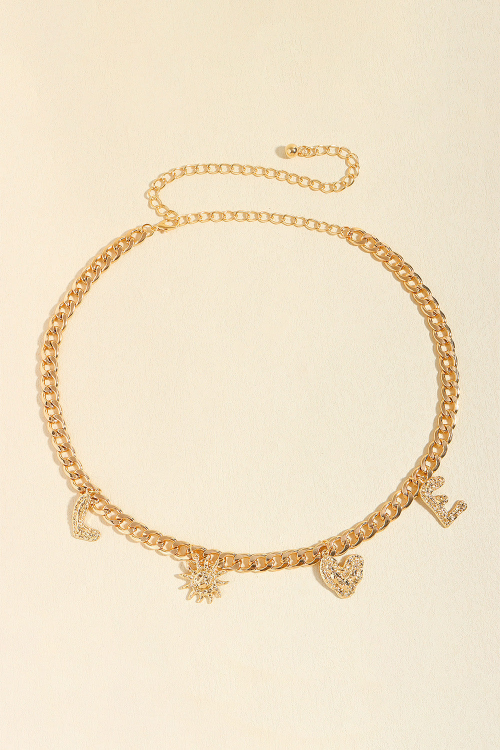 Gold chain belt with charms including letters L, E, a sun, and a heart.