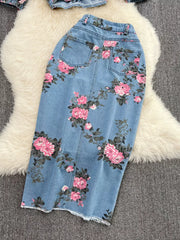 Denim midi skirt with pink floral print and frayed hem.