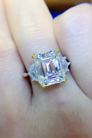 Emerald cut trilogy ring in silver with gold accents and clear stones