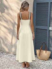Beige A-line midi dress with black trim straps and hem.