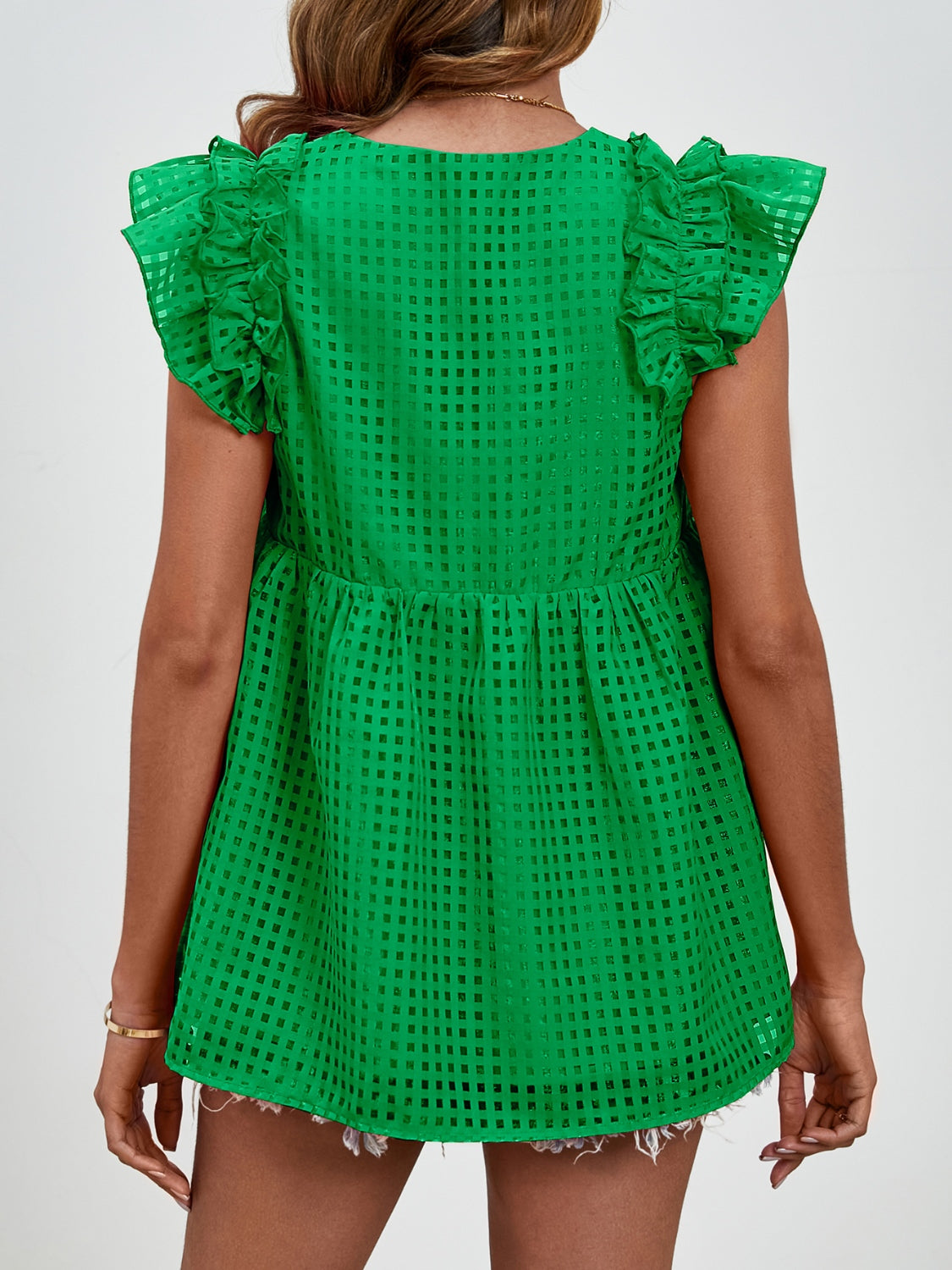 Dark green textured trapeze blouse with ruffle cap sleeves and a gathered waist.