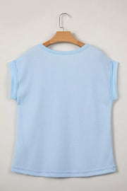 Light blue waffle knit t-shirt with cuffed sleeves and curved hem.