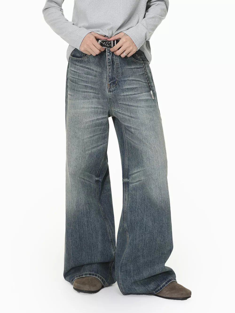 Men's wide leg denim jeans in faded blue wash with a relaxed fit.