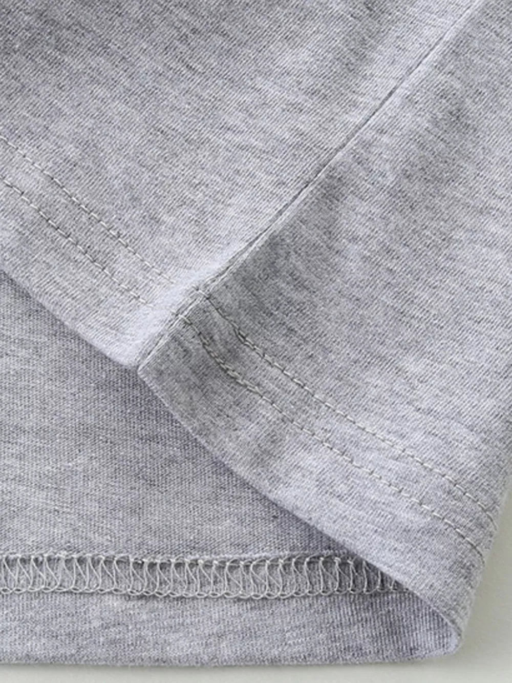 Toddler grey cotton t-shirt detail showing hem and seam stitching